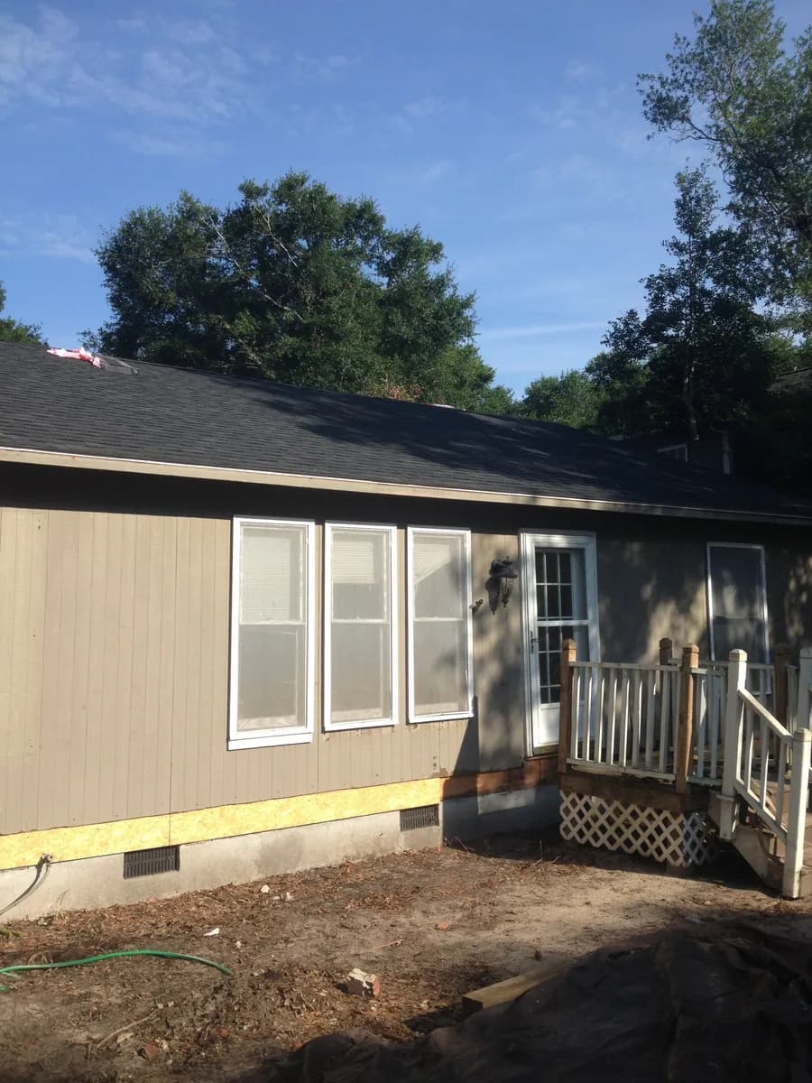 Later exterior room view with windows, trim, and wall finish visible