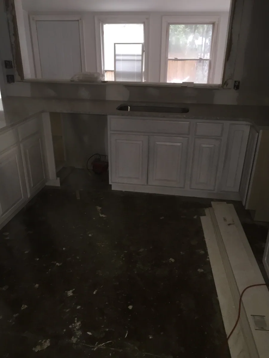 Kitchen installation with base cabinets and peninsula framing in place